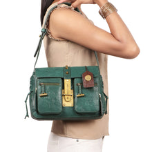 Load image into Gallery viewer, A woman carrying a stylish green leather Hidesign shoulder bag with front pockets and gold hardware.